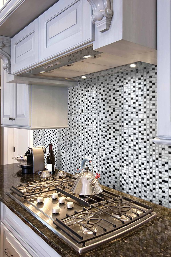 Kitchen stove with mosaic tile backsplash